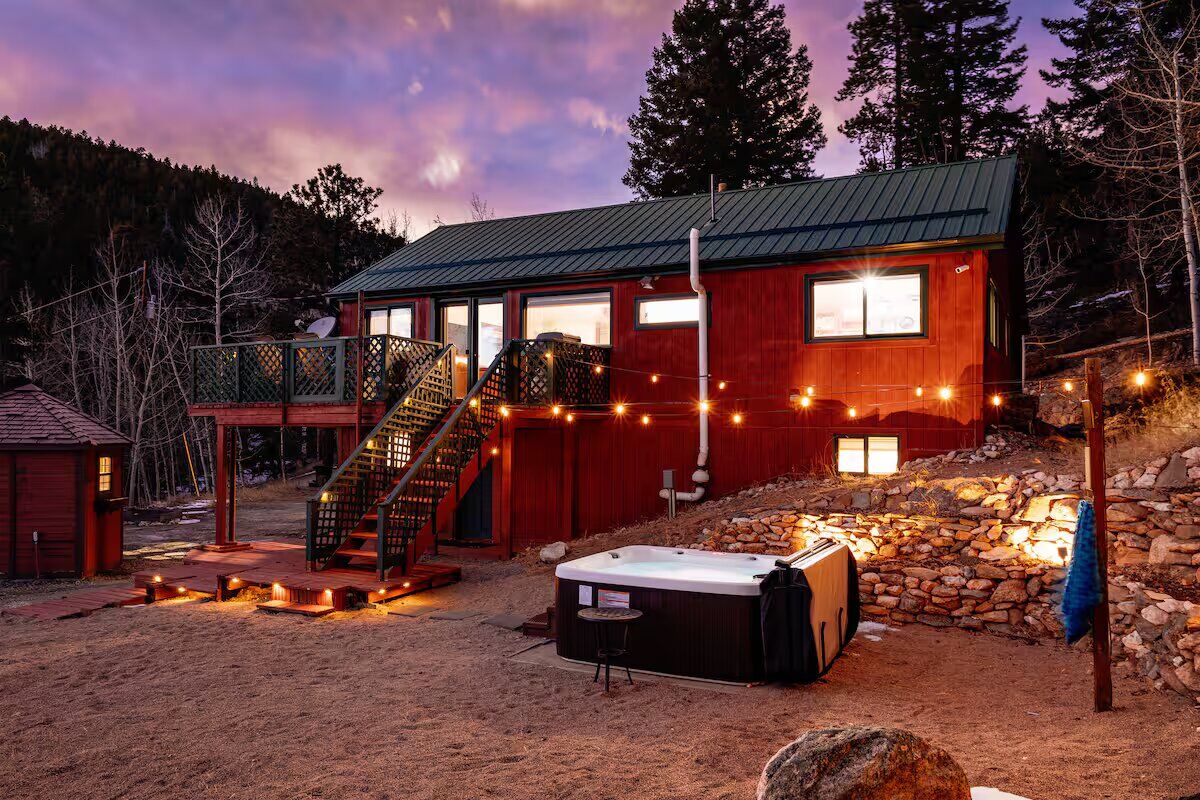 Colorado mountain cabin short-term rental managed by Home Remedies Property Management, dusk exterior with hot tub